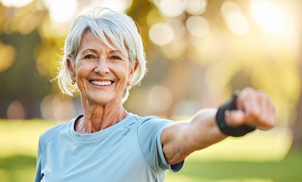 Femme âgée souriante s'exerçant en plein air