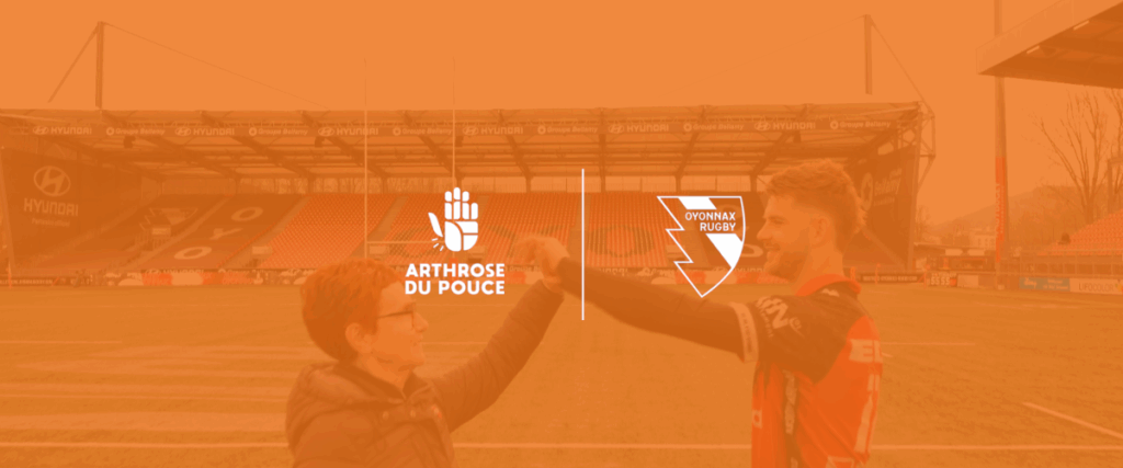 Deux personnes se saluent sur un terrain de rugby.